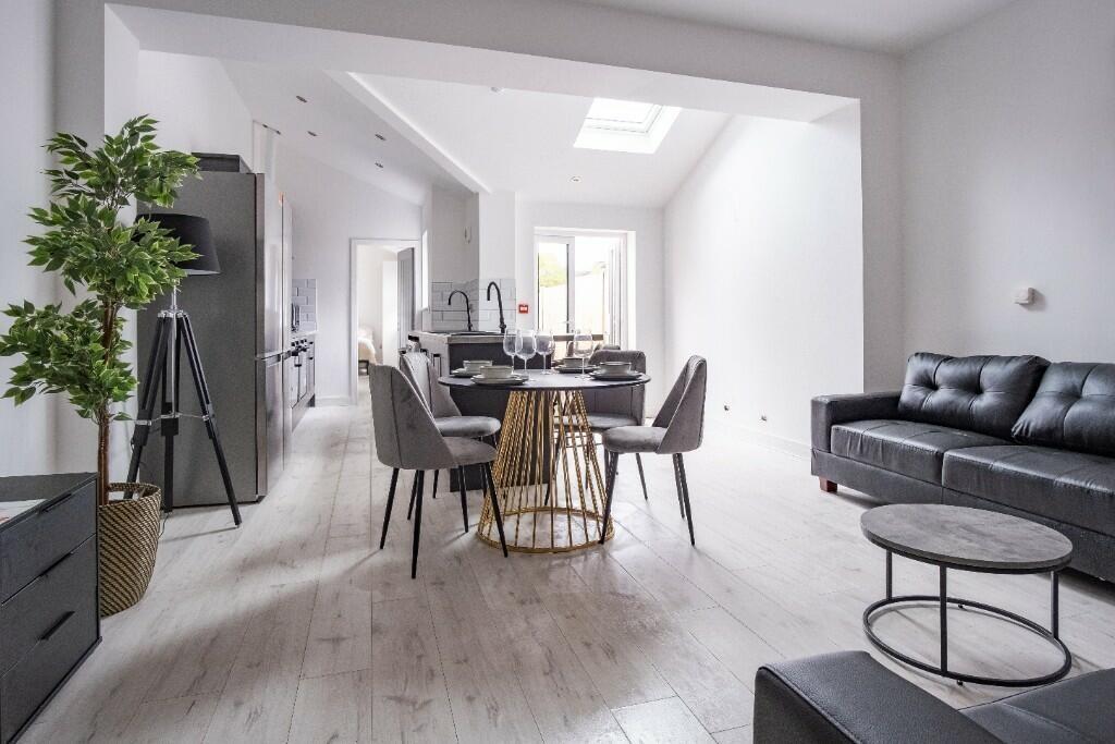 A bright, spacious living room featuring contem...