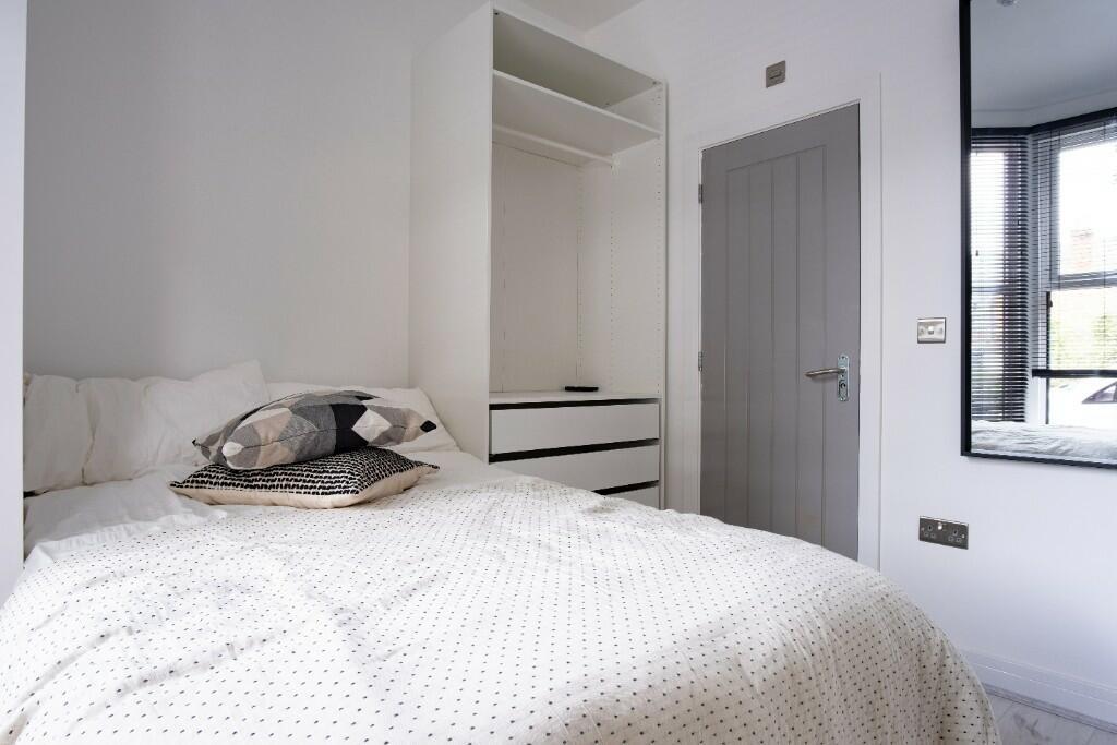A bright and inviting double bedroom featuring ...