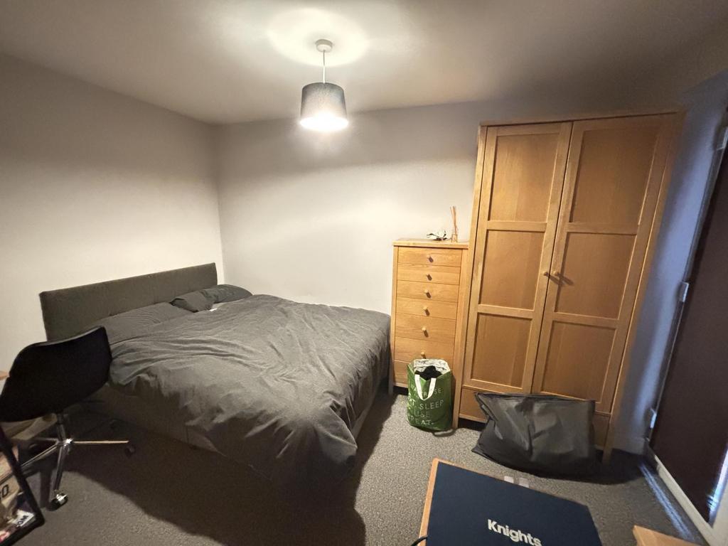 A well-maintained bedroom featuring a double be...