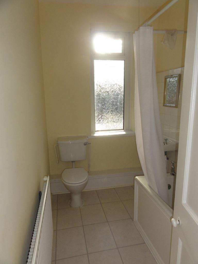 Bright and clean bathroom with a frosted window...