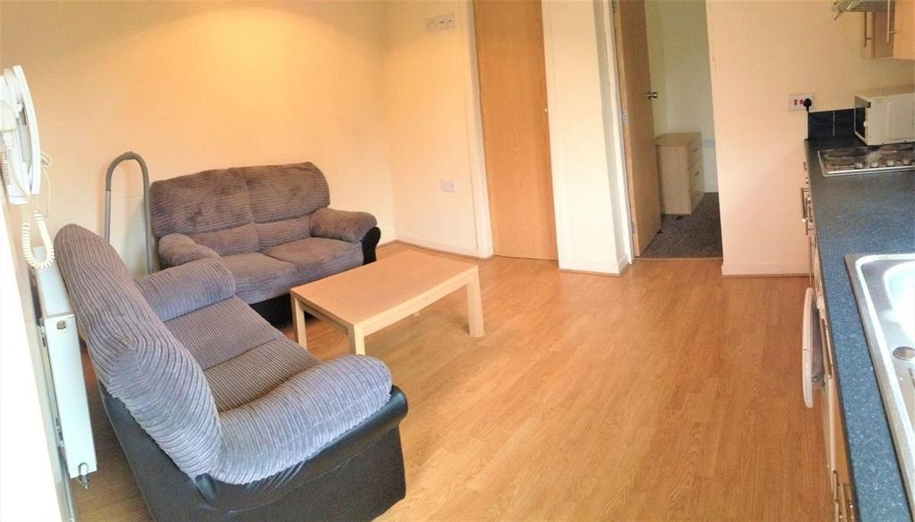 A bright and welcoming living room featuring tw...