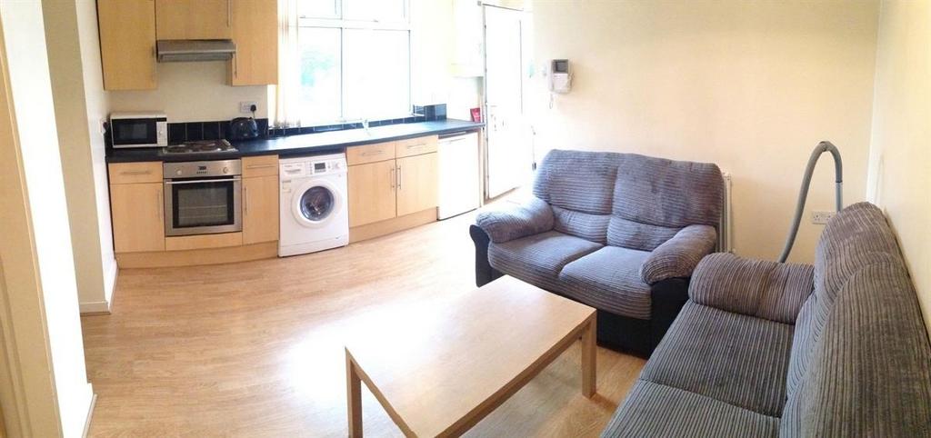 Bright open-plan living area with a matched sof...