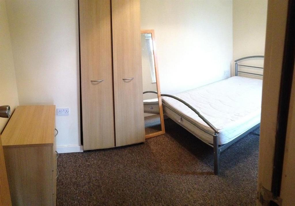 Simple furnished bedroom with a single metal-fr...