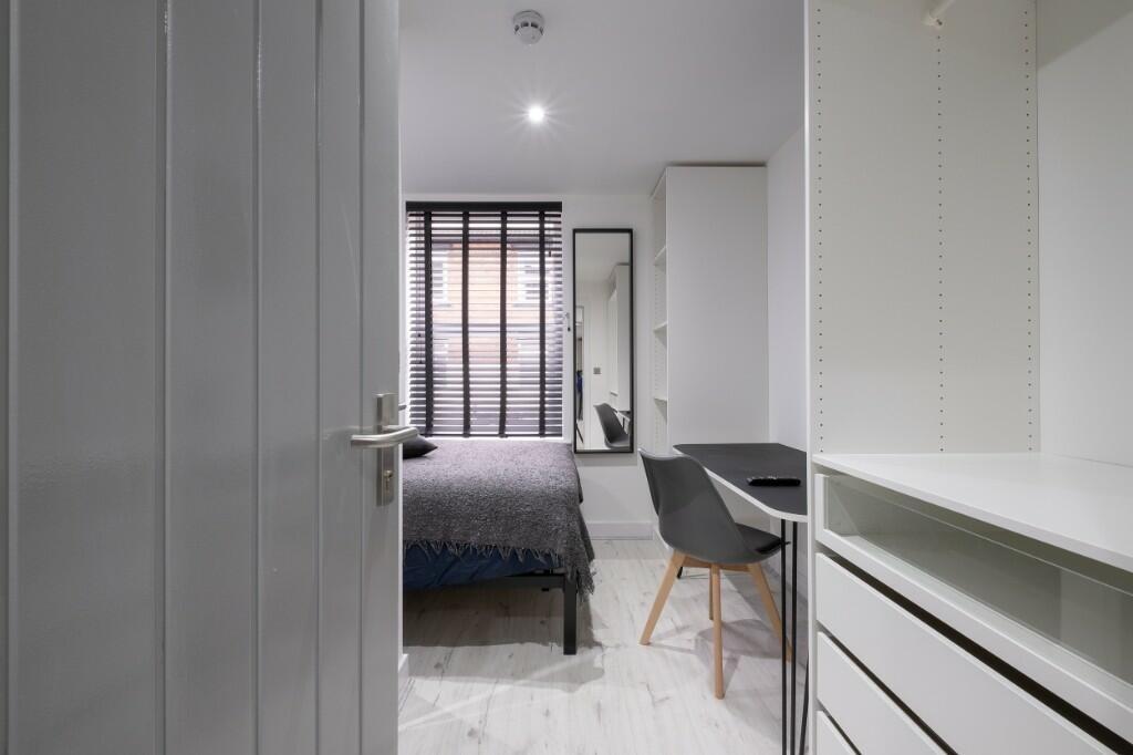 Bright, modern bedroom with a neatly made doubl...