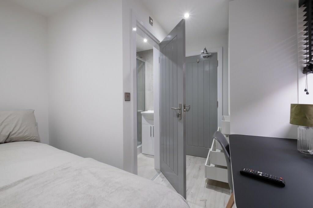 Bright, neatly presented bedroom with a comfort...