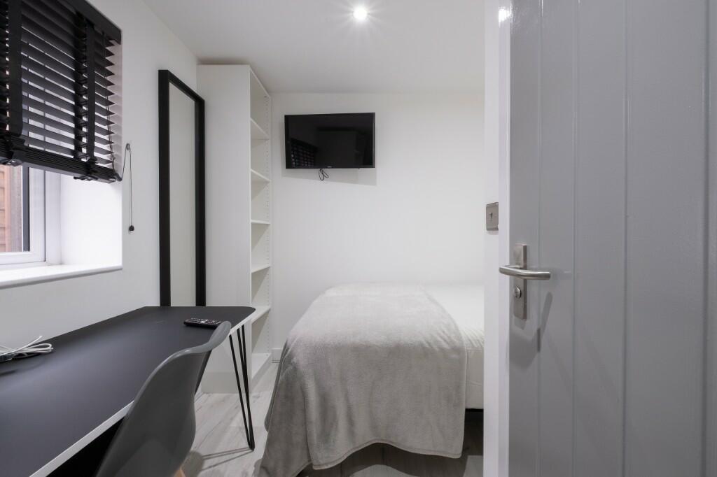 Bright, neatly presented bedroom with a modern ...