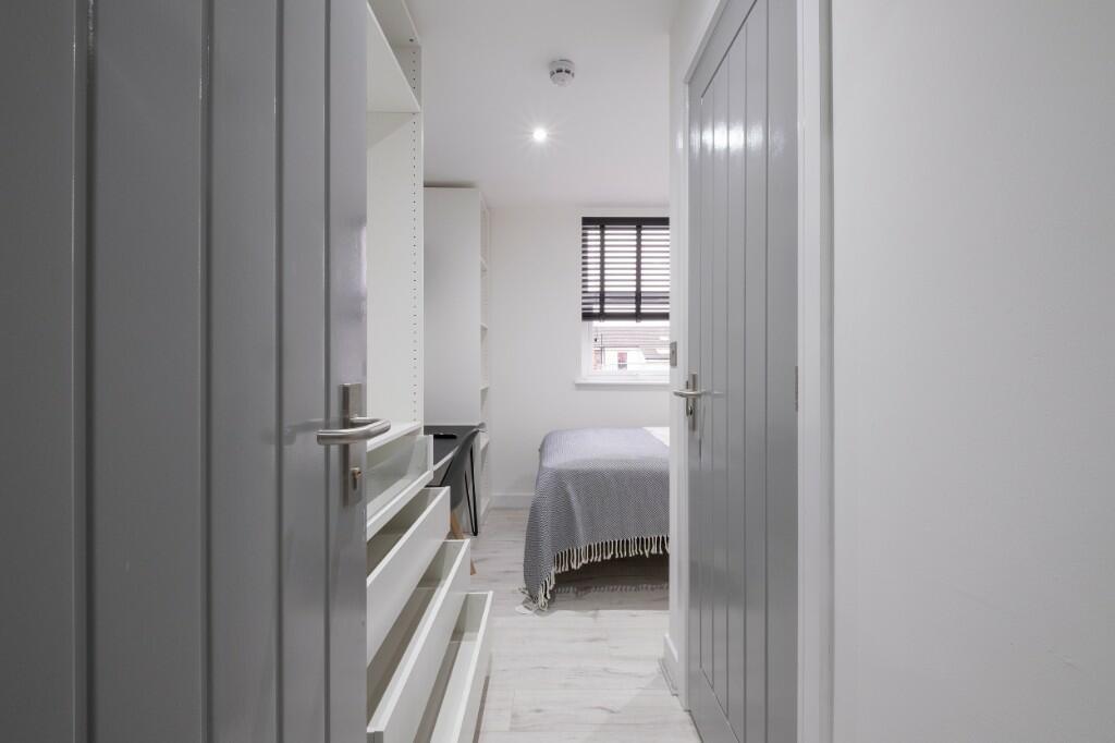 Bright, modern bedroom with neutral decor, rece...