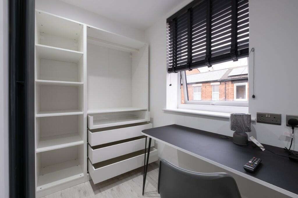 Bright, tidy study area with built-in shelving ...