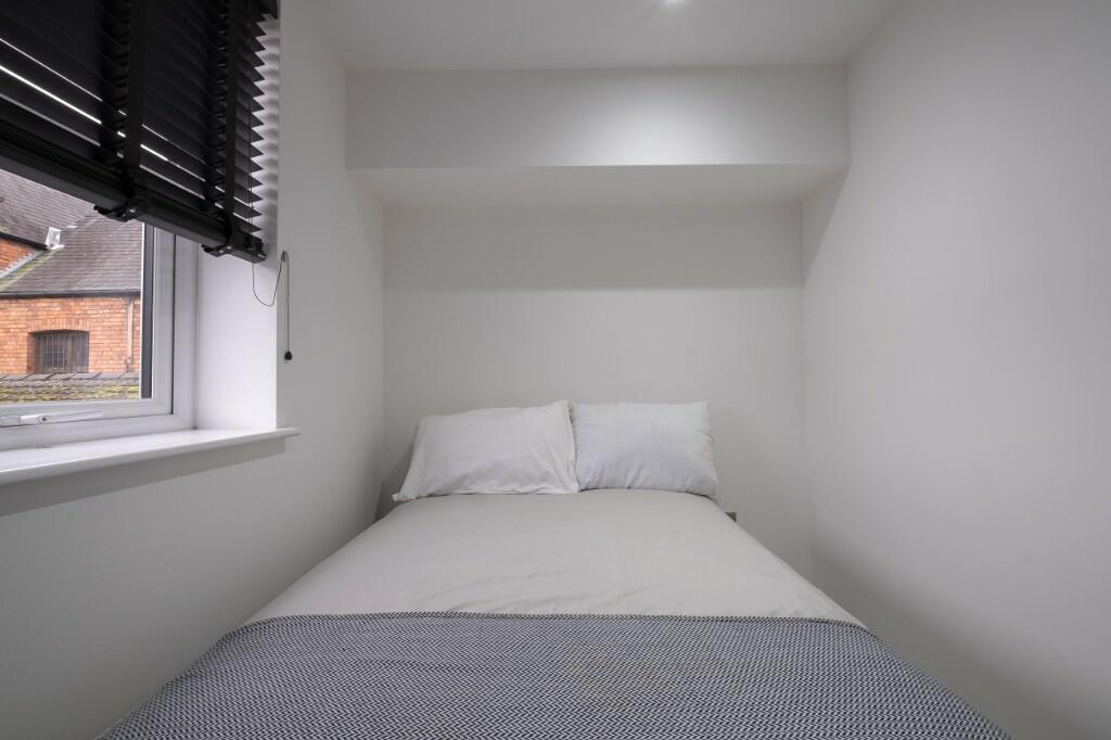 Bright, neatly presented bedroom with a comfort...