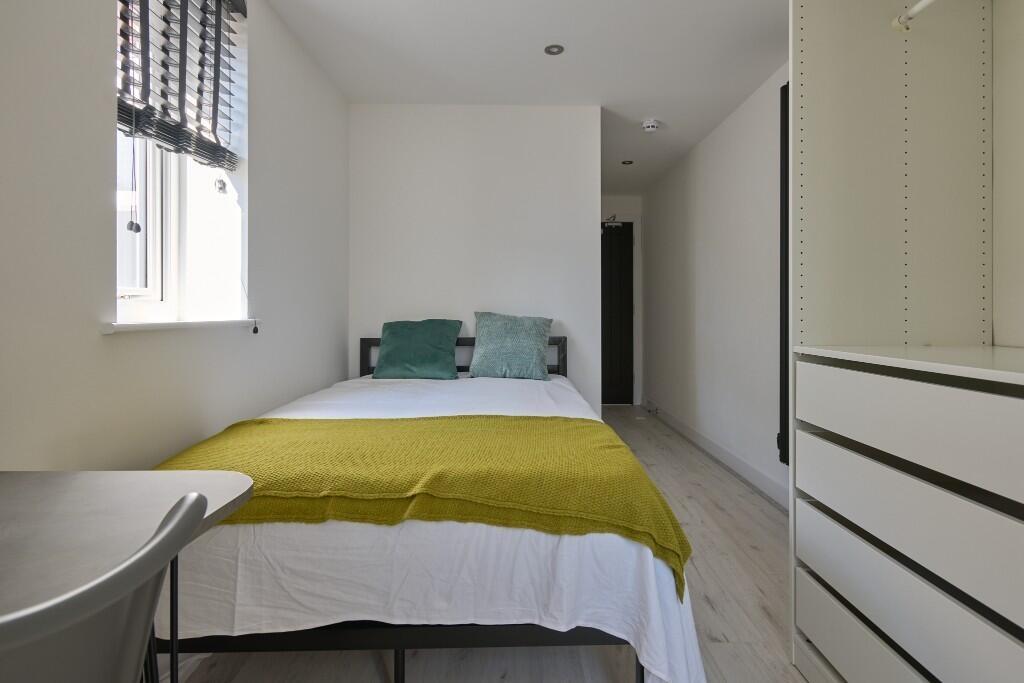 Bright, neatly presented bedroom with a comfort...
