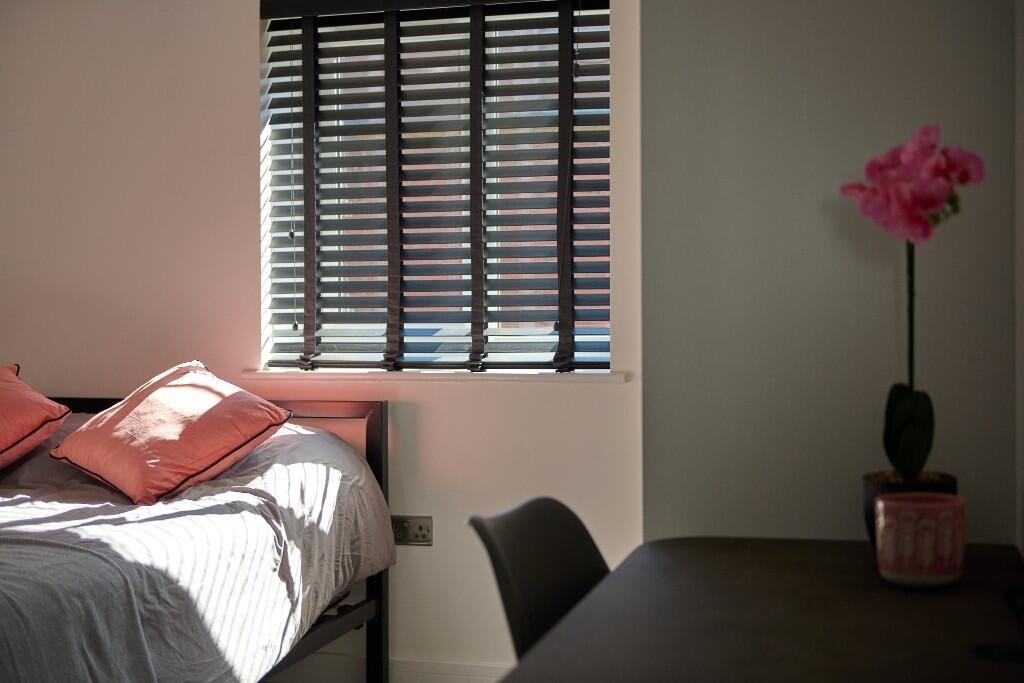 Bright, neatly presented bedroom with a comfort...