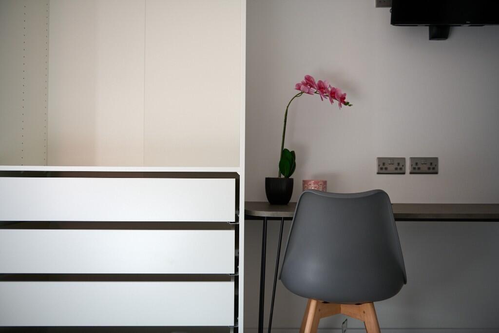 Bright, modern bedroom corner featuring a sleek...
