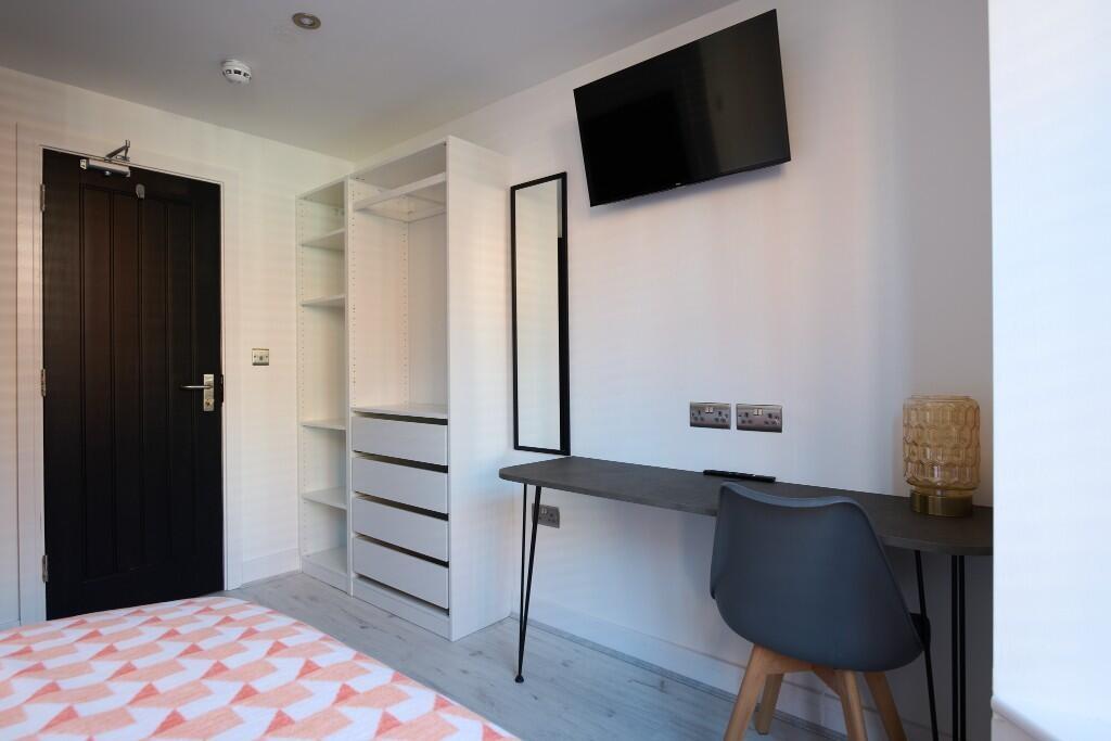 Bright, modern double bedroom with a fitted war...