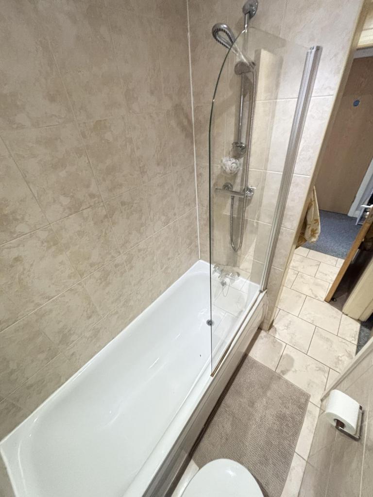A modern bathroom suite featuring a spacious ba...