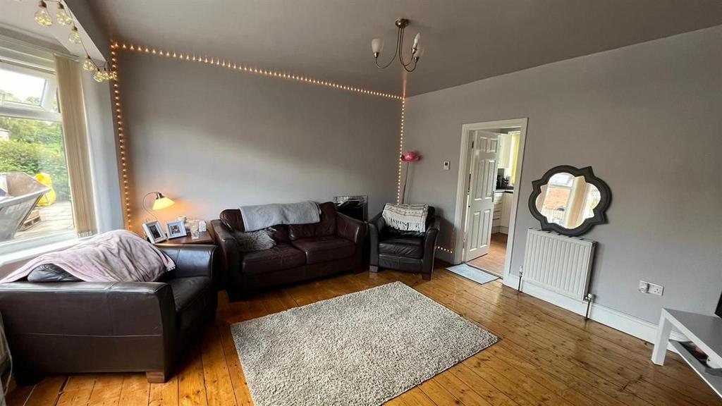 Spacious and well-lit living room featuring com...