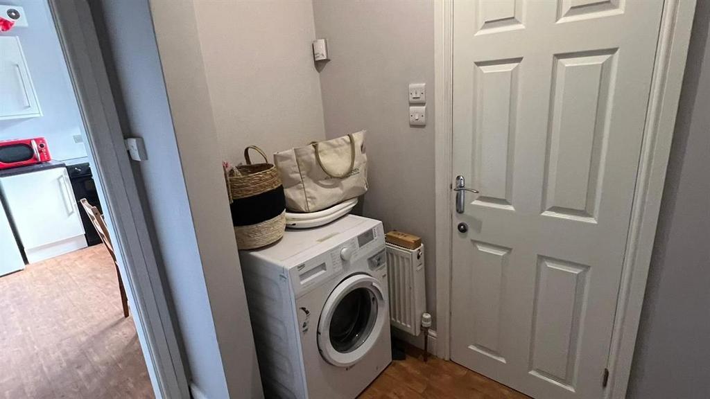Neat entry hallway with a compact utility area ...