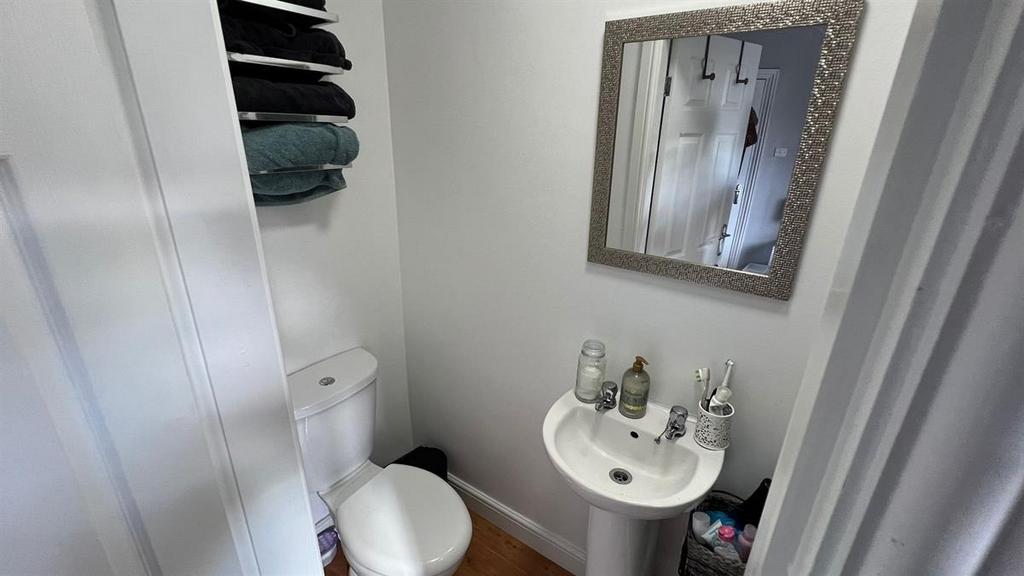 Bright, tidy bathroom with a pedestal sink, mir...