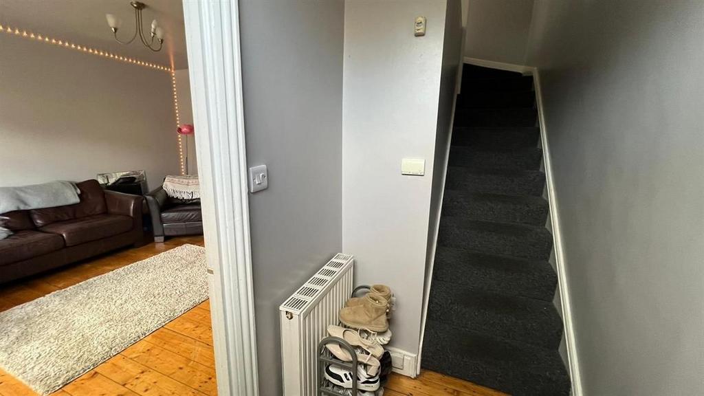 Well-kept hallway with neutral walls, carpeted ...