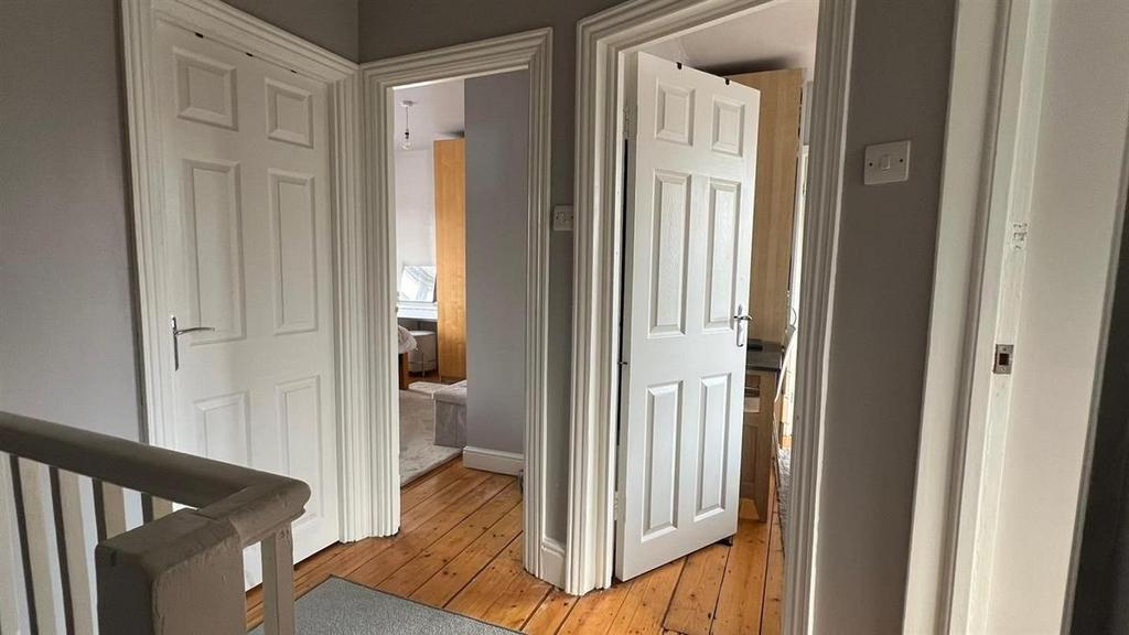 Bright, neutral hallway with painted walls, woo...