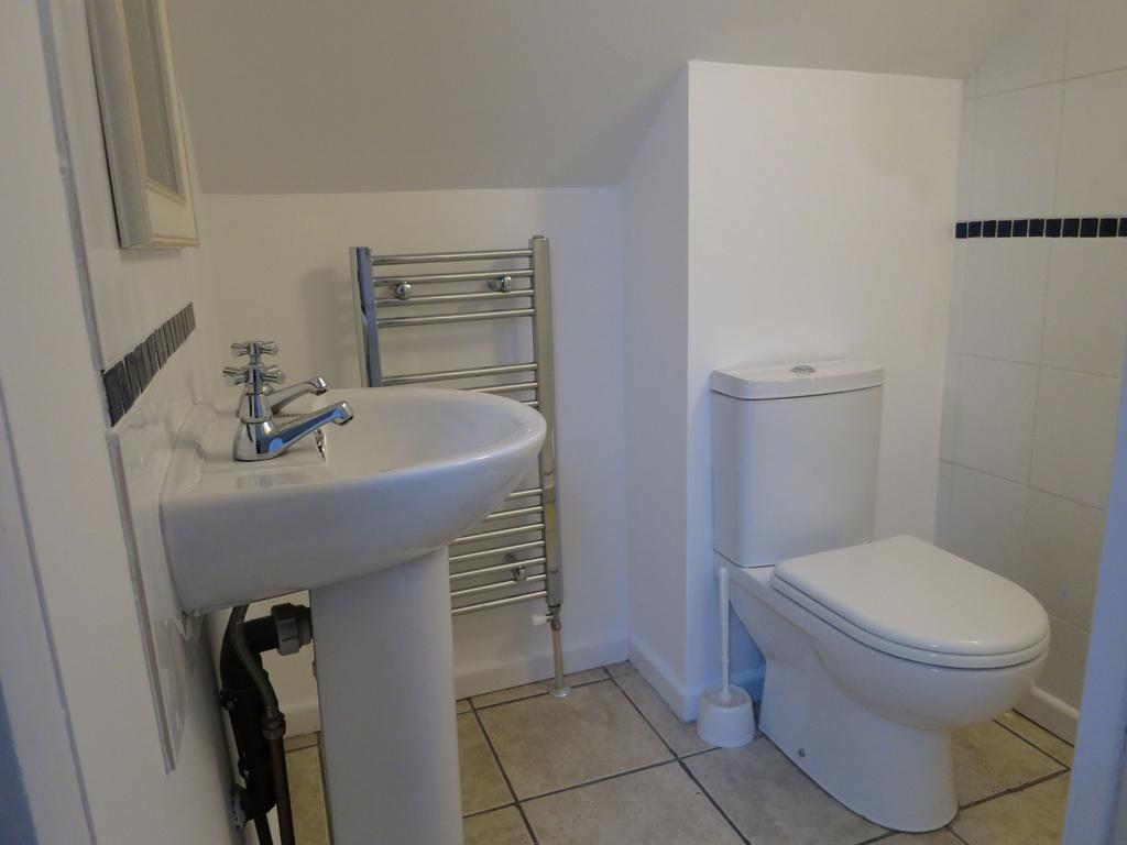 A clean, modern bathroom featuring a white toil...