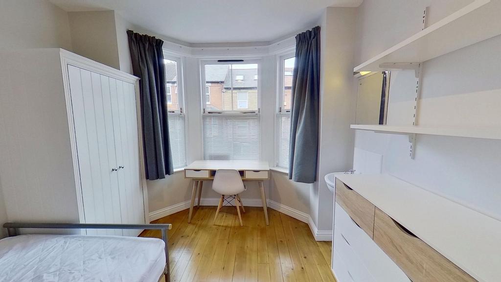 Bright, well-maintained bedroom featuring a lar...