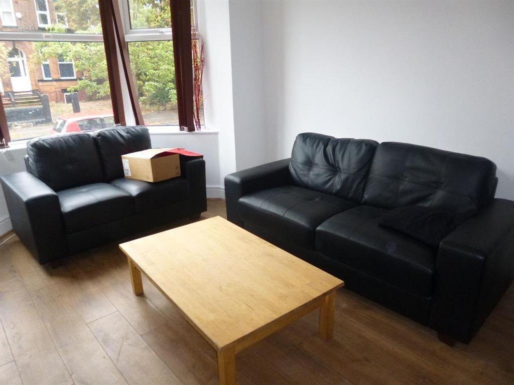 A bright and inviting living room featuring two...