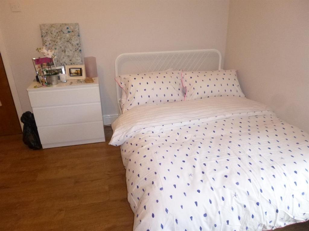 A bright and inviting double bedroom featuring ...