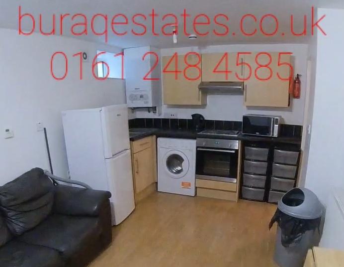 Open-plan kitchen area with modern appliances, ...