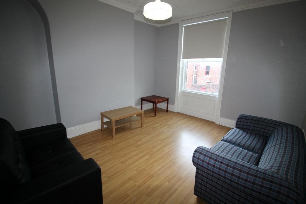 A bright and spacious living room featuring a l...