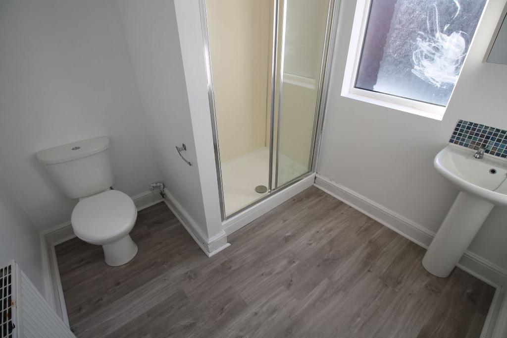 A clean, modern bathroom featuring a toilet, a ...