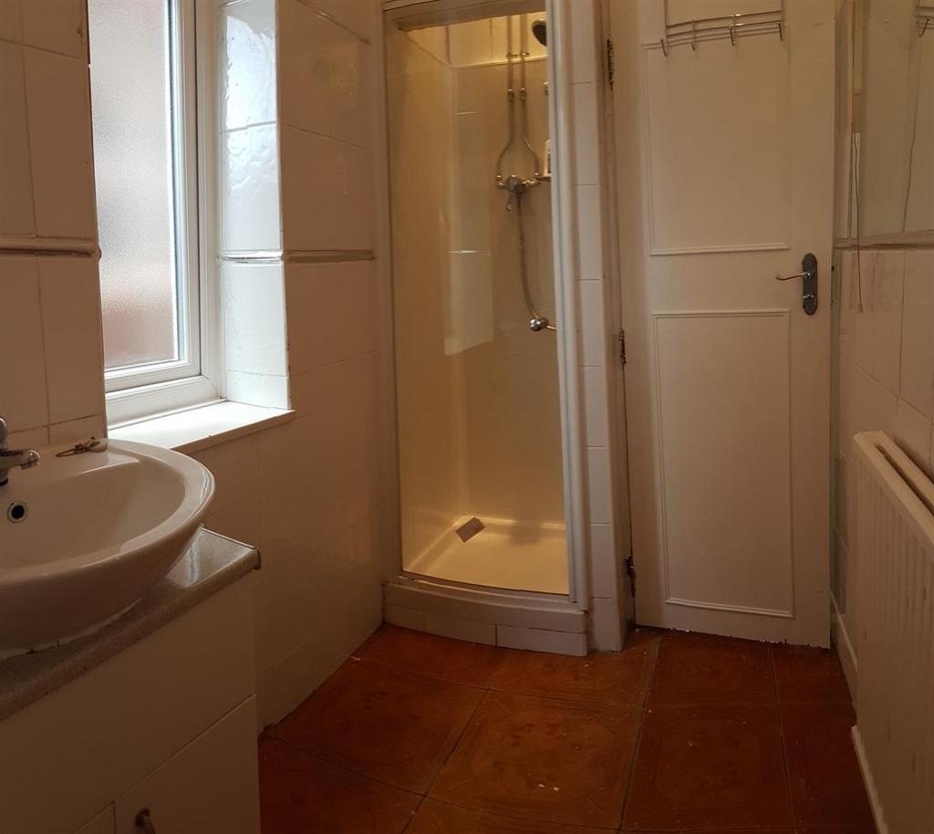 A clean and well-maintained bathroom with a sho...