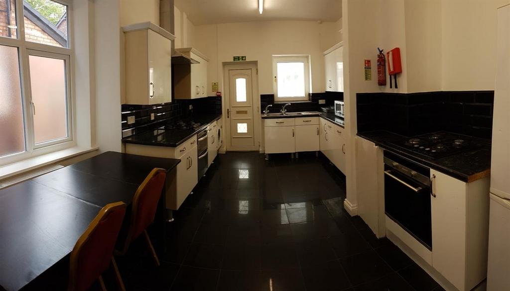 A well-lit, modern kitchen with ample counter s...