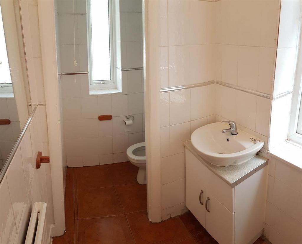 A clean and bright bathroom featuring a sink wi...