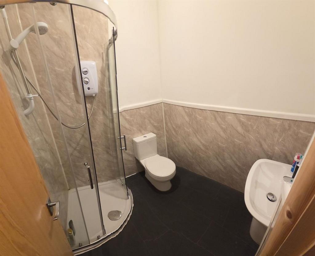 Modern bathroom with a corner glass shower encl...