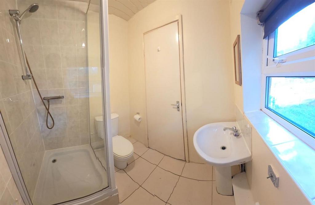 Bright, clean bathroom with a modern shower enc...