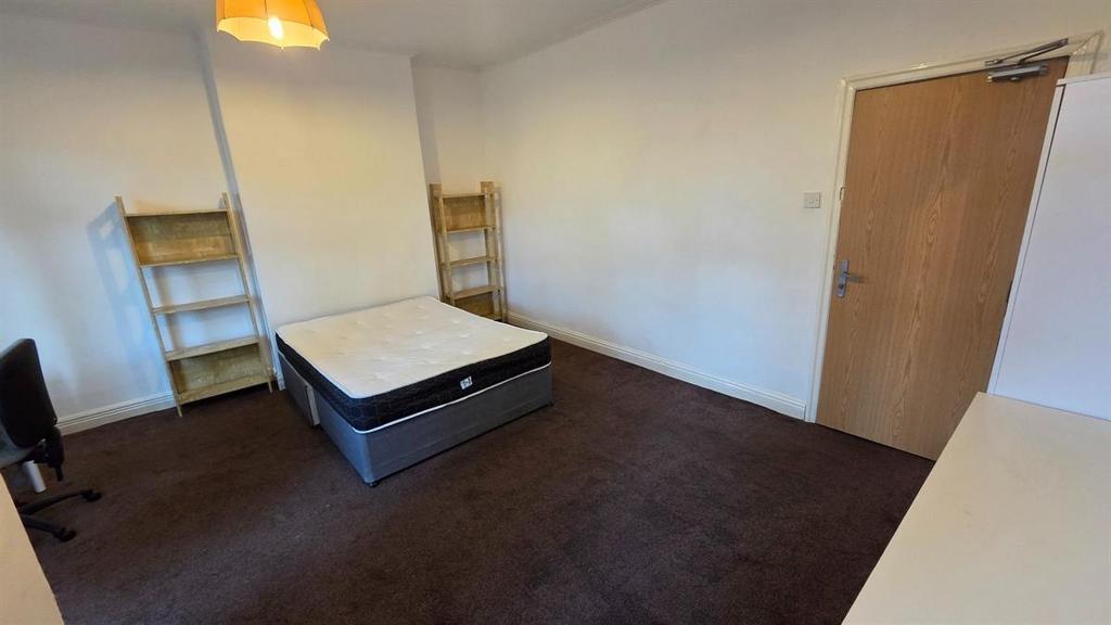 Bright, uncluttered double bedroom with neutral...