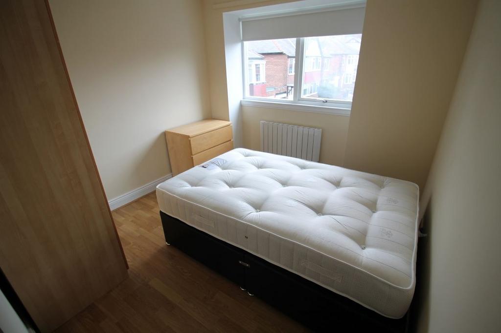 A cozy and well-maintained master bedroom featu...