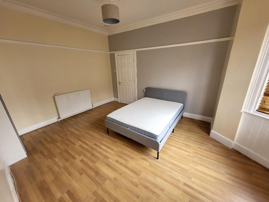 A spacious master bedroom featuring ample natur...