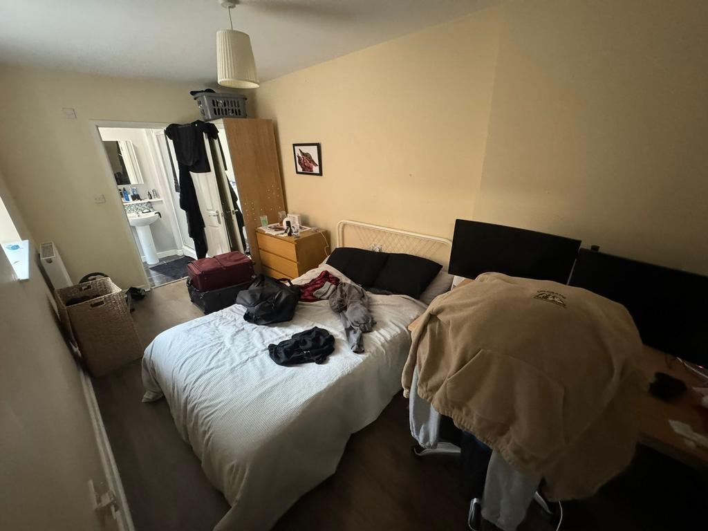 Bright double bedroom with a central double bed...