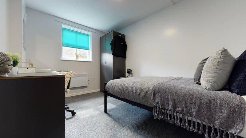 A bright, well-maintained bedroom featuring a l...