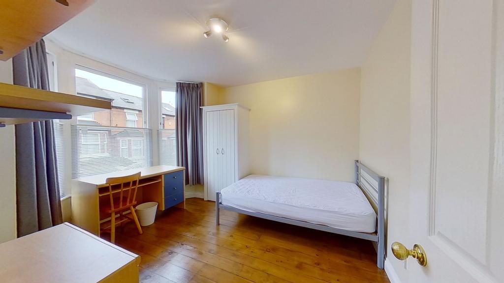 Bright, well-presented bedroom with wooden floo...