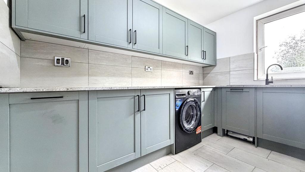 Bright modern utility-style kitchen with soft b...
