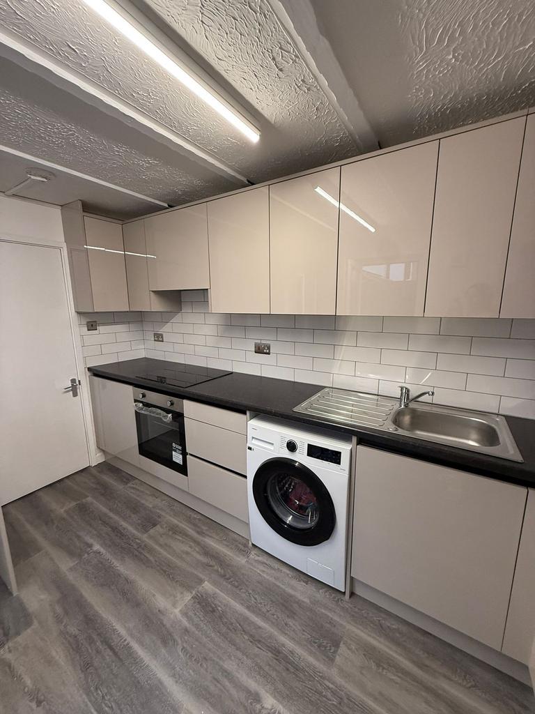 This modern kitchen features sleek cabinetry an...
