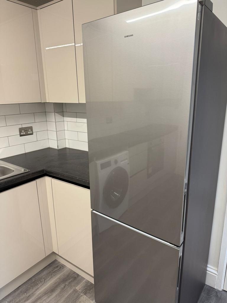 A modern kitchen featuring sleek cabinetry and ...