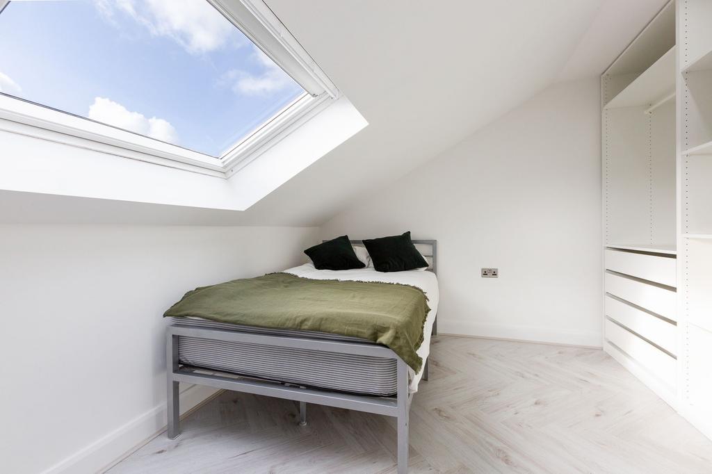 Bright and minimalist single bedroom featuring ...