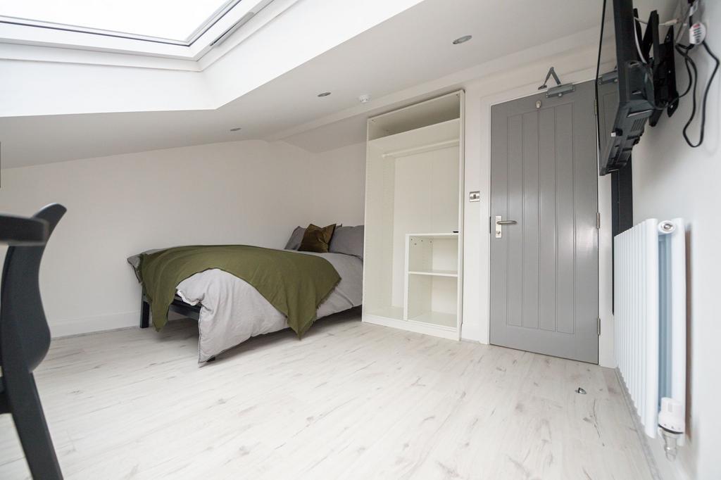 Bright and cozy bedroom with ample natural ligh...