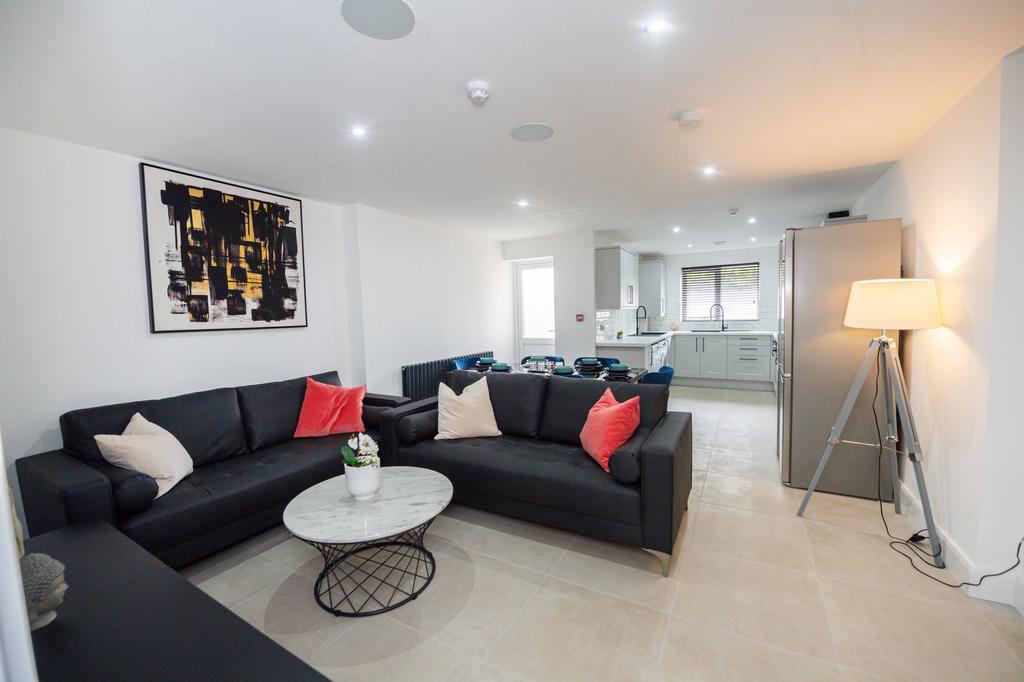 A modern, spacious living room featuring comfor...