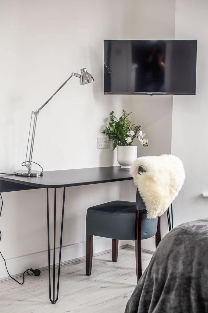 A modern living room featuring a sleek wall-mou...