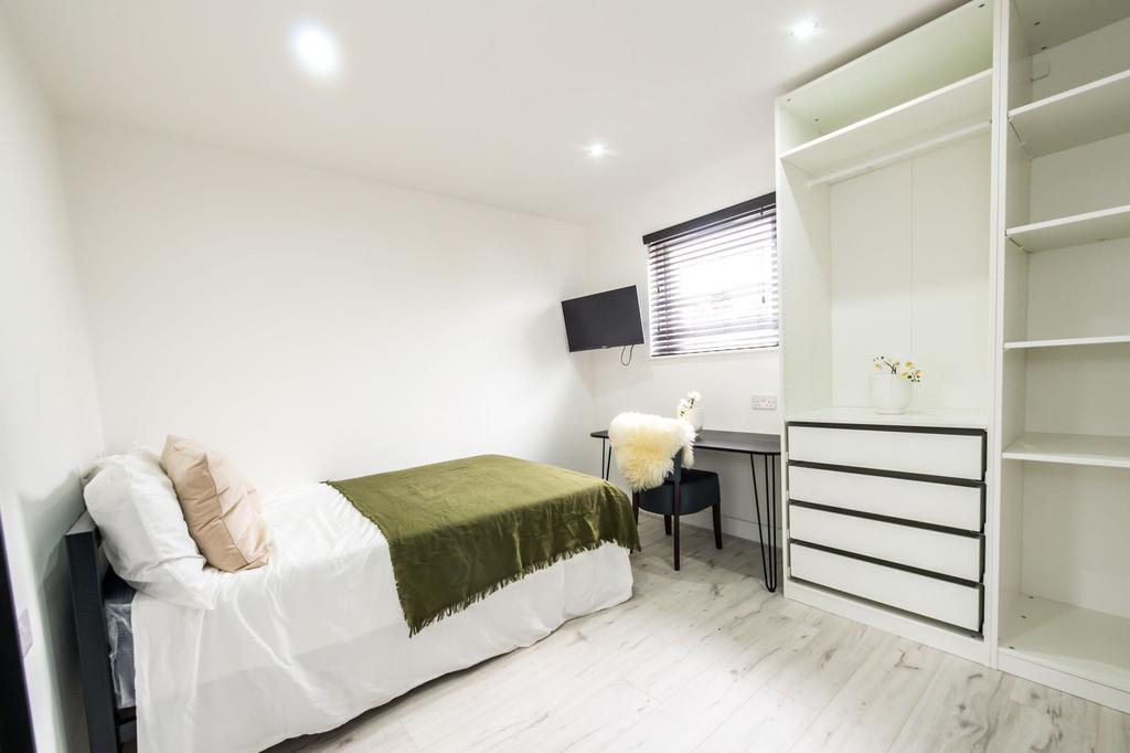 Bright, modern double bedroom featuring a comfo...