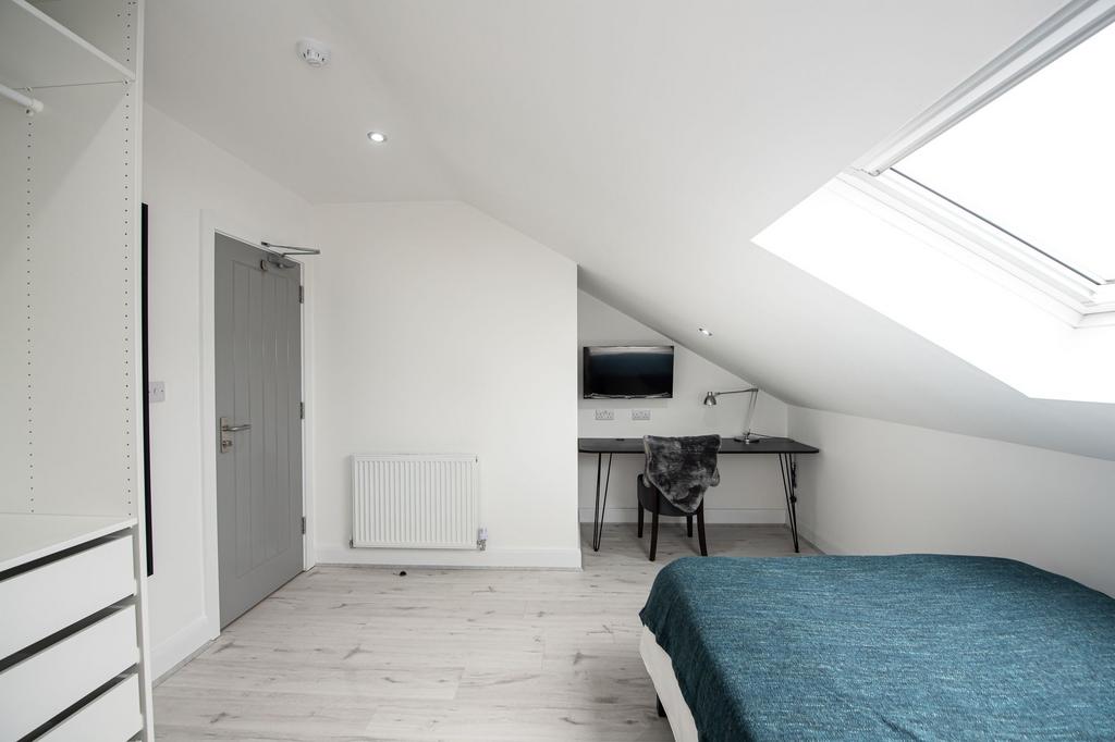 A bright and airy bedroom featuring a comfortab...